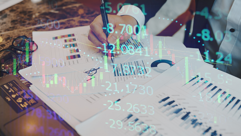 Office worker holding a pen on his right hand as he reviews sheets of paper with charts. There is also an overlay of a candle stick chart and numbers.