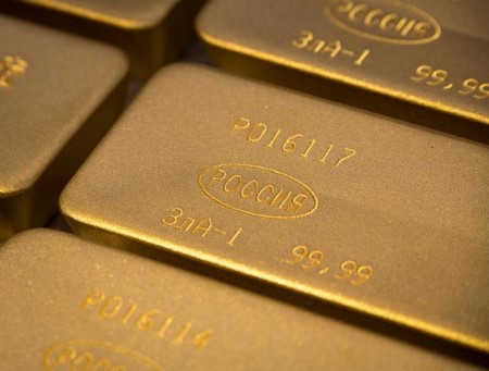 Gold falls to two-week low as higher dollar, yields dent appeal