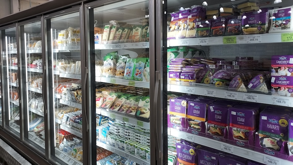 Grocery refrigerator with food items.