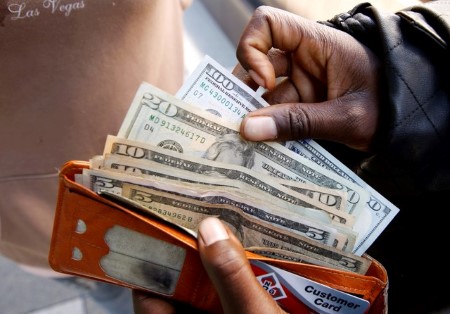 Dollar slides against peers, weighed down by fresh tariff worries