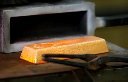 Gold gains on dollar weakness, safe-haven demand
