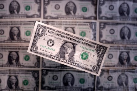 Dollar hits near 4-year low versus euro, weighed by worries over tax bill, trade deal