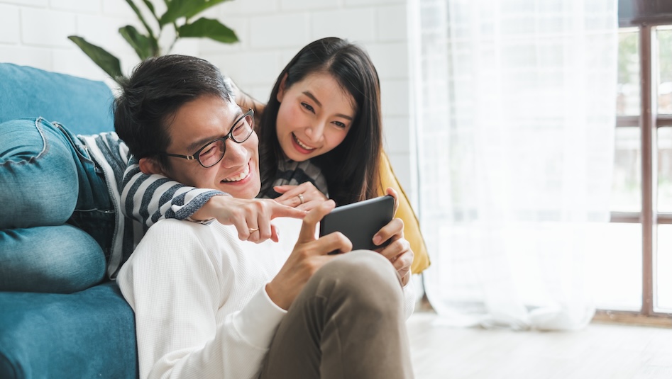 Couple in the living room looking at a tablet