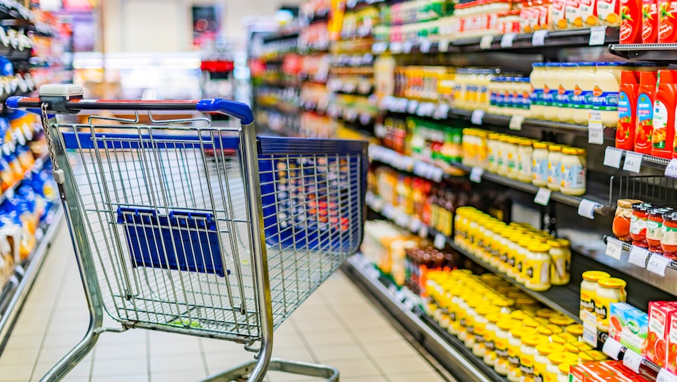 Empty grocery cart in the middle of the aisle
