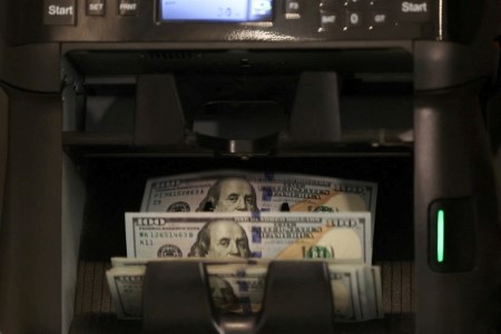 Dollar steady as investors eye release of US data backlog