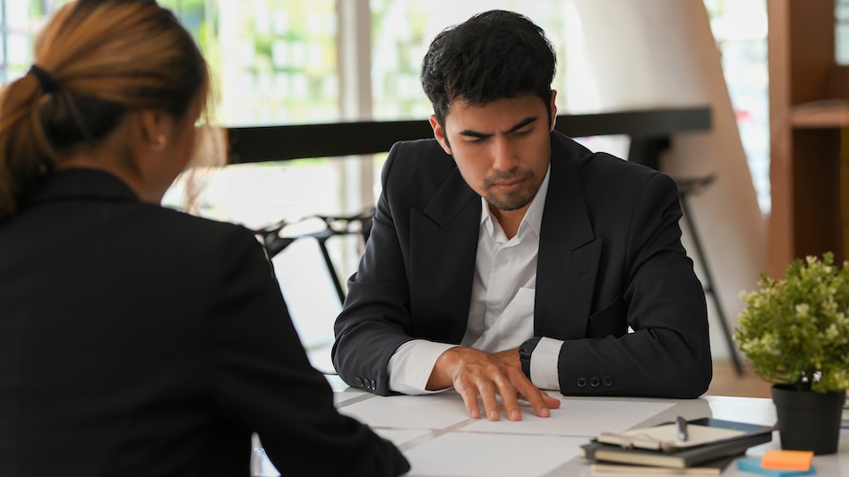 Male executive poring over papers